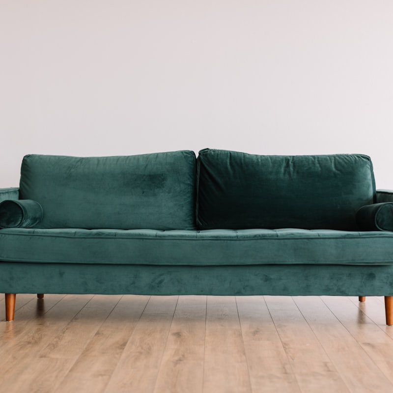 A green mid-century sofa in the furniture section
